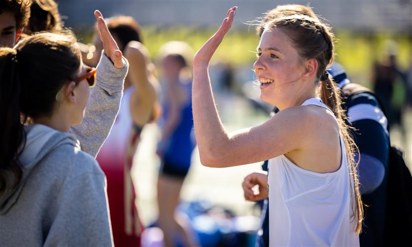 A runner high fives a friend